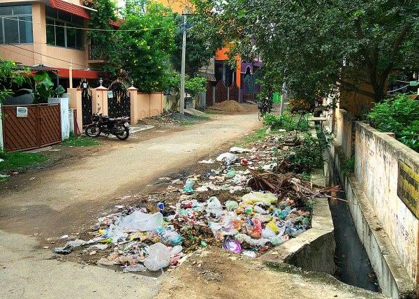 Uncollected trash accumulates at an intersection