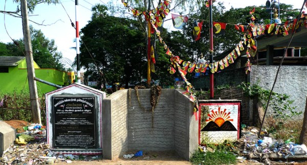 political flagpoles surrounded by trash in Tamil Nadu
